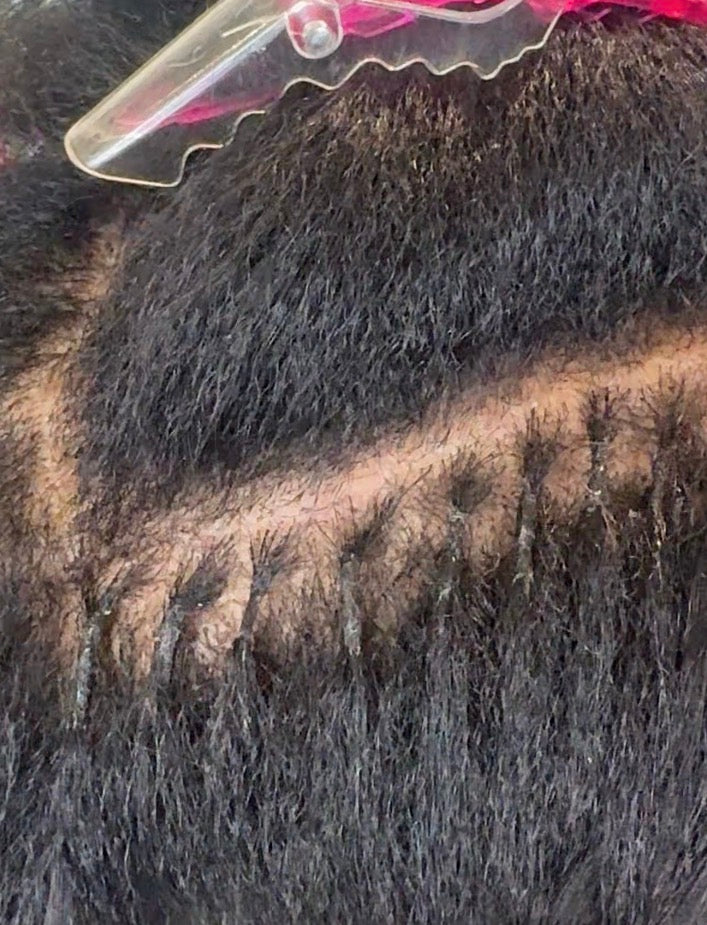 Close-up of k-tip hair with a section pulled out using a hair clip.