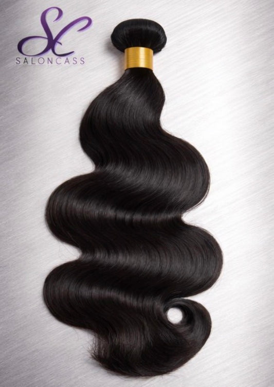 Black hair bundle with a gold clip on a gray background, featuring the SalonCass logo.