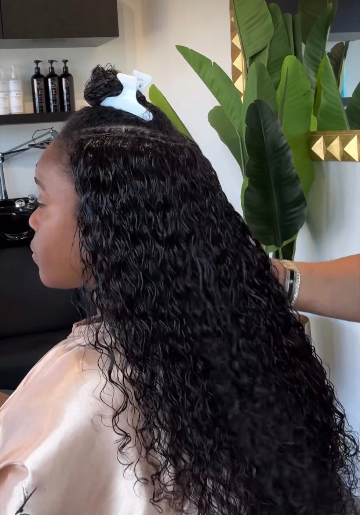 Person with styled hair in a salon setting Hair By Shaunda Cass